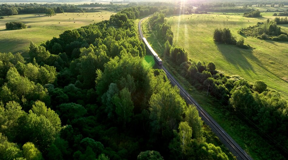 Train travelling through green countryside. 